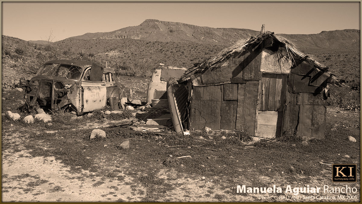 RELICS OF THE PAST OLD CAR SHACK IN DESERT MOUNTAINS