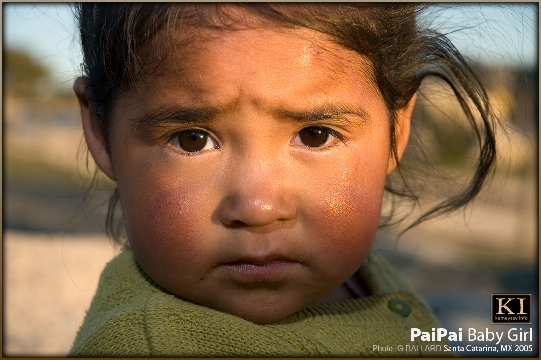 Baby Indian girl portrait in sunbeam desert sunset